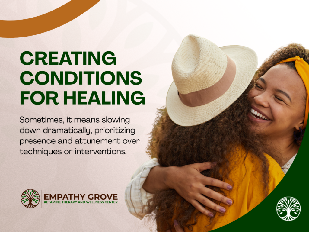 Two women embrace and smile warmly outdoors. The text reads: Creating conditions for healing, whether through slowing down or exploring options like ketamine therapy. Presence and attunement come first. Empathy Grove logo included.