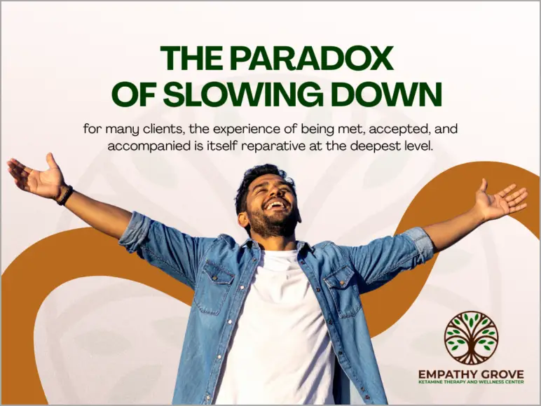 A smiling man with outstretched arms stands in front of a graphic background. Text reads, The paradox of slowing down, highlighting the healing power of acceptance for those affected by complex trauma, with the Empathy Grove logo at the bottom.